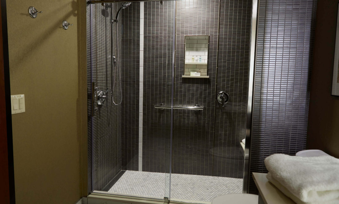 Elegant tiled shower in a hotel suite