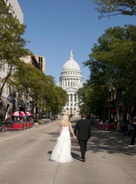 Wedding couple walking on State Street in Downtown Madison WI