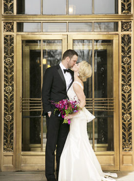 Wedding couple kissing in front of Park Hotel in downtown Madison WI